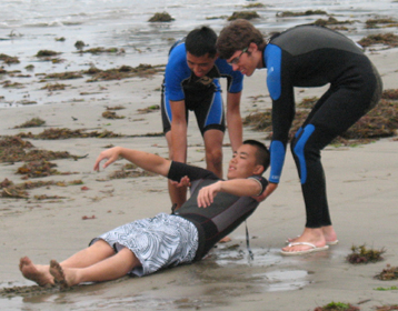 2 rescuer beach drag 2010: two lifeguard candidates drag a victim along the sand