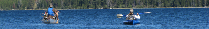 Alexander Mitchell and Alanna Klassen paddling: canoeist and kayaker on large lake