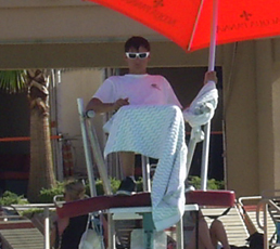 Las vegas hotel lifeguard with feet on rescue tube: Las vegas hotel lifeguard in a stand on duty with his feet on his rescue tube instead of having the tube ready for a rescue