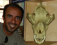 Rajiv and skull: wide-eyed grinning man next to skull