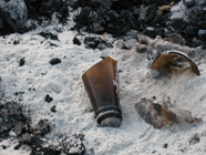 broken bottle in sand at campfire: broken beer bottle in sand at beach campfire area