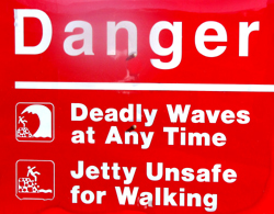 danger deadly waves at any time: a sign that says danger deadly waves at any time, jetty unsafe for walking