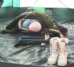 2010 winter trip girl in tent with multiple sleeping pads and bags: posed photo of girl in a huge tent with multiple sleeping pads under her and three sleeping bags