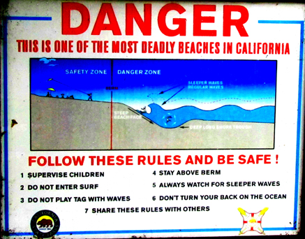 sign one of the most dangerous beaches: a sign that says Danger this is one of the most deadly beaches in California