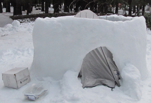 unfinished igloo with tent inside: unfinished igloo with tent pitched inside