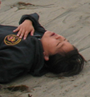 waterfront guard practice victim: waterfront guard practice victim pretending to be unconscious on a beach