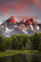Teton range at sunset by Ron Niebrugge: At the top of this picture, bright clouds, below that, Teton peaks, below that, forest and in the foreground, water. used with permission from the photographer, Ron Niebrugge
