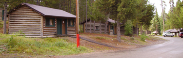 3 colter bay cabins rainy morning 2010: log cabins with paths to roadside