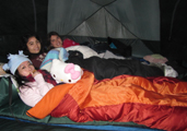 3 girls in tent winter 2011: 3 smiling girls in their sleeping bags in a tent