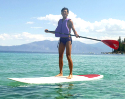 Howard Mok stand up paddle board unknown photographer: smiling man on a stand up paddleboard on Lake Tahoe