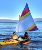 Chris Throm and Jennifer Chiou sailing photo by Alpana Shekar: guy and gal in an ocean kayak with sail kit