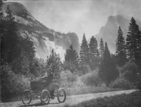 Stanley Steamer and Half Dome.: Arthur Holmes and Frank Holmes from San Jose, California, drive a Stanley Steamer on a dirt road in Yosemite with Half Dome in the background, circa 1900. Photo from the Yosemite Museum.