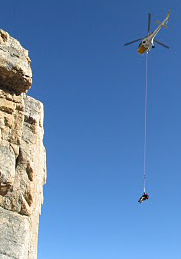 Teewinot rescue NPS photo: rescuer and rescued victim hang below a helicopter