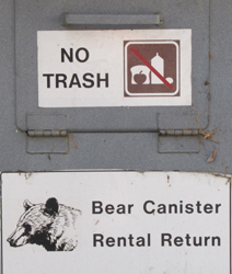 bear canister rental return: a sign that says bear canister rental return