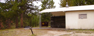 colter bay tent cabin: canvas walled cabin with wood sides showing the patio