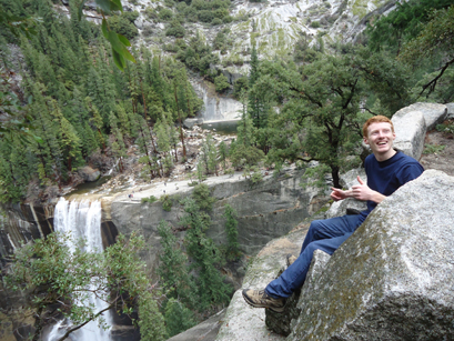 Darrell Vaughn at Clark's Point above Vernal Fall in Yosemite photo by Thuy Tien Nguyen: man sitting on edge of cliff above a waterfall