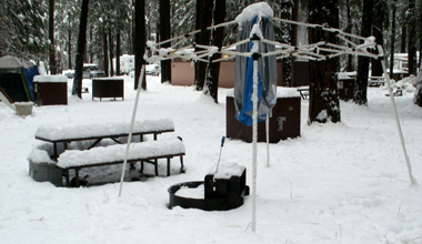 dining canopy frame with cover removed in snow: deep snow in campsite, dining canopy frame standing up, but with cover removed