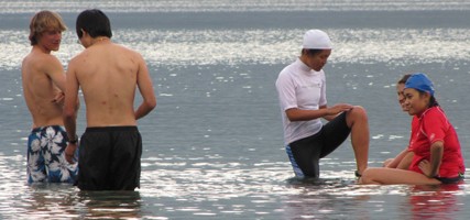 standing or sitting on a log after swimming: standing or sitting on a log after swimming