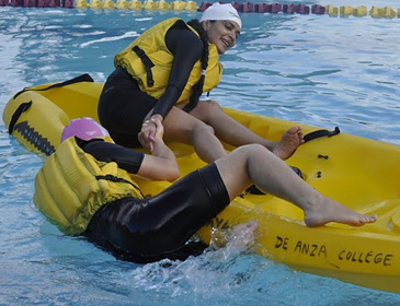 getting back into a kayak photo by Sumana Praharaju: woman in a kayak gives a hand to another woman trying to climb in