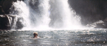 swim by falls: Mary swimming by a waterfall at Glen Aulin.