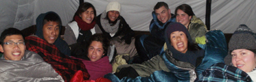 group in tent winter 2013: a bunch of people sitting up in their sleeping bags in a tent