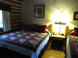 jenny lake lodge cabin interior: jenny lake lodge cabin interior with quilts on the two beds