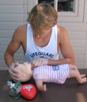lifeguard Ethan Wilkie checks for object: lifeguard Ethan Wilkie checks for object in infant manikin's mouth