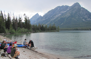 lunch at leigh lake 2011 200 pixels: people sitting on logs and on a kayak at lakeside