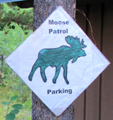 moose patrol parking: sign with an image of a bull moose and the words moose patrol parking
