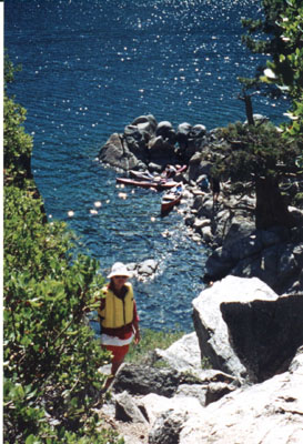 Fannette I: hiker on trial to the top of Fannette Island looking down towards cove with kayaks below