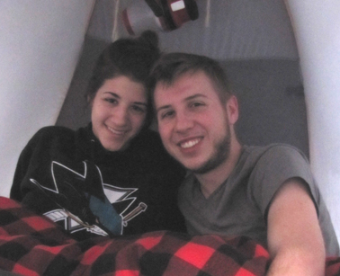 snow camp 2015 couple in tent: two people in a tent first thing in the morning