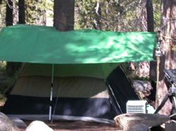 tent with tarp set up overhead: 