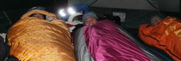 three in tent winter 2013 yosemite: three people in sleeping bags in a tent just waking up