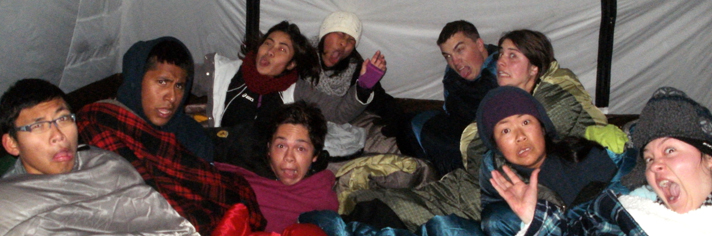 unhappy with too many people in tent 2013: a bunch of people sitting up in their sleeping bags in a tent making faces
