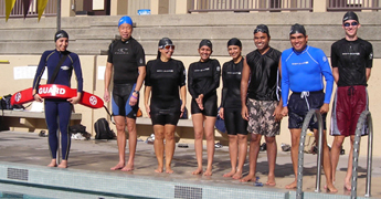 180 pixel rash guards: eight people standing on a pool deck, wearing rash guards