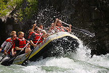 wyoming rafting by Ron Niebrugge: the front of a white water raft is lifted into the air, photo used with permission from the photographer Ron Niebrugge