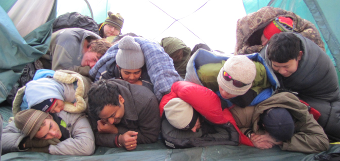 2010 snow camp group sleeping 320 pxls: 12 people in sleeping bags in three rows on top of each other in an eight person tent, pretending to be sleeping