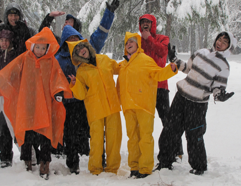 2011 snow camp group photo in campsite: nine people posing for a gorup photo during a heavy snow fall
