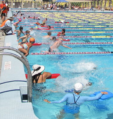 2012 kids tri jumping in: kids jumping into pool at start of swim race