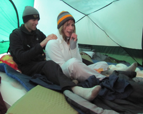 Alex gives Alanna a backrub: giving a backrub in a tent