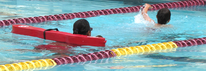Christina Bolanos keeping an eye on a triathlete: triathlon lifeguard follows a tired swimmer