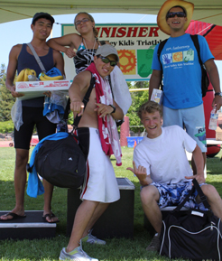 photo by Joyce Kuo lifeguard group photo after the kid's tri: Silicon Valley Kids Triathlon lifeguards Jeremiah Chua, Emily May, Herland Antezana, Ethan Wilkie and Javier Puente pose after the race for a group photo by Joyce Kuo.