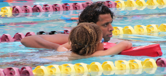 Jerome Ward assisting a swimmer: triathlon lifeguard swimming with a swimmer