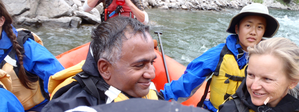 Kanishka, Christina and Mila white water rafting: a few people on a raft
