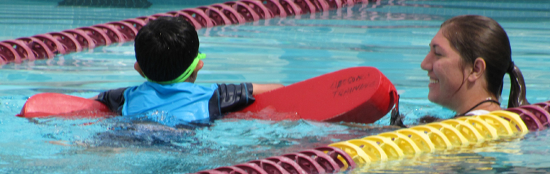 Laura Stark assisting swimmer: triathlon lifeguard assists swimmer