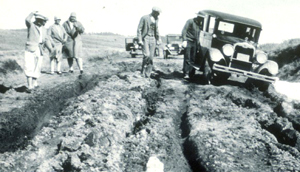 NPS 1920s car on deeply rutted road: 1920s car stuck in mud on deeply rutted road
