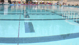 Olympic sized pool with kayaks from water edge at shallow end: 