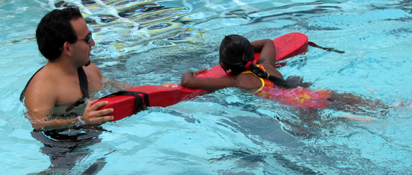 Raul Alba assisting swimmer: triathlon lifeguard assists a swimmer