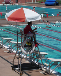 Avery Aquatic Center lifeguard with feet on rescue tube: 
