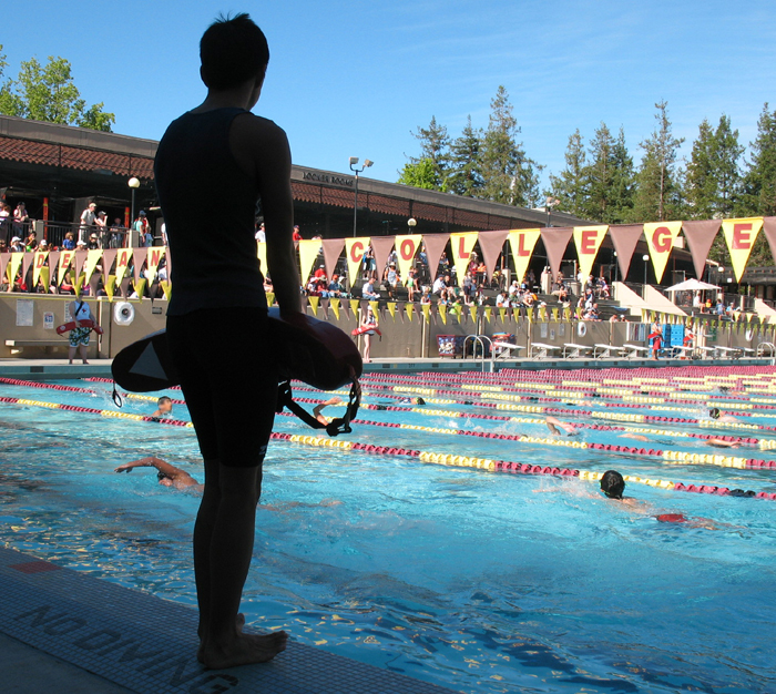 guardingtheSiliconValleyKidstri: lifeguard silhouetted against pool of swimmers photo by Alan Ahlstrand, lifeguard instructor and volunteer of record for De Anza College